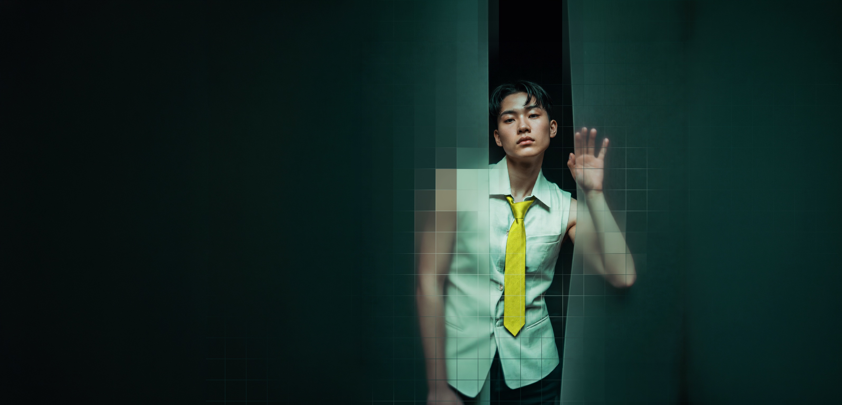 A person reaching toward a translucent glass surface